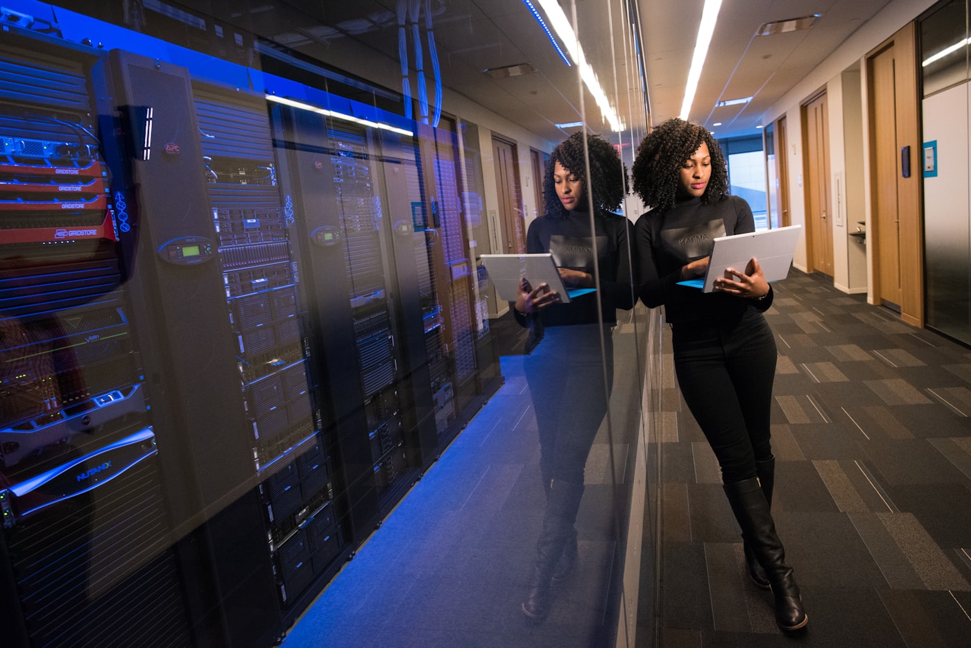 Professional working with a laptop in a modern office corridor